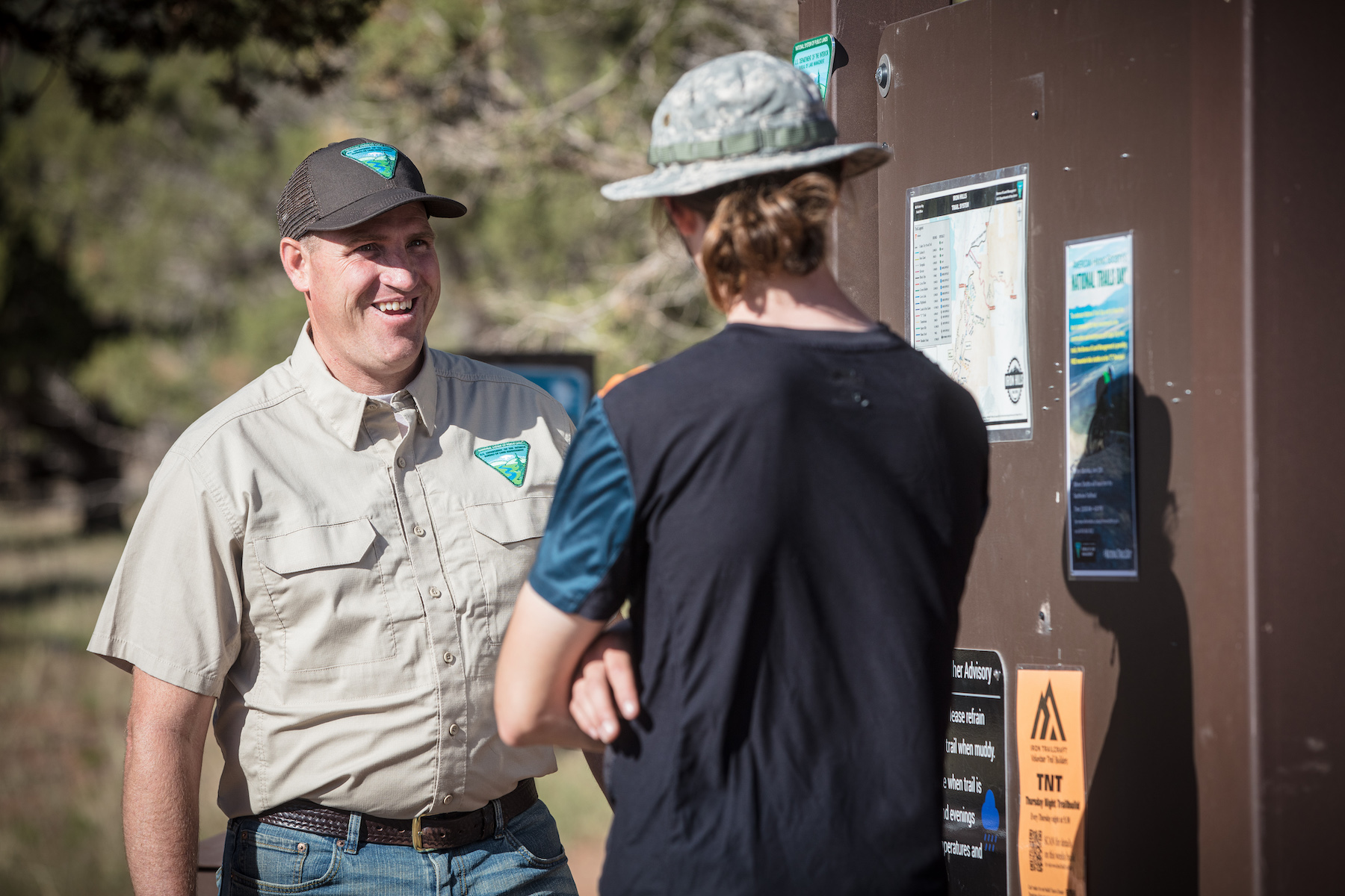 Two individuals discussing at a Trail Management School